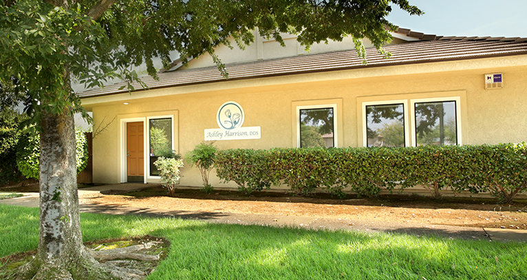 The exterior of our building is a bright, happy yellow color with our logo on the side wall.