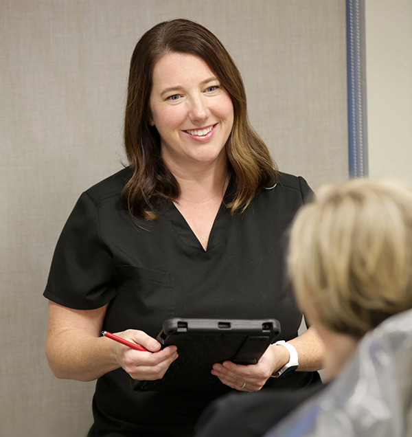 Dr. Ashley Harrison chatting with a patient in their office.