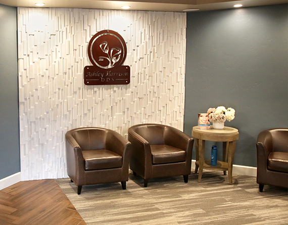The interior of our lobby shows leather chairs around the exterior wall, teal walls, and hardwood floors.