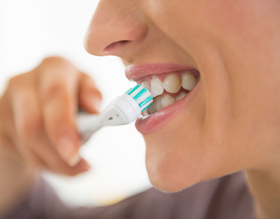 a woman brushing her dentures