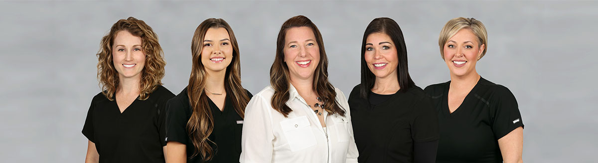 Group photo of all five staff members that work at Ashley Harrison DDS