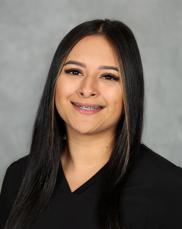 A headshot of Vanessa who has long black hair.