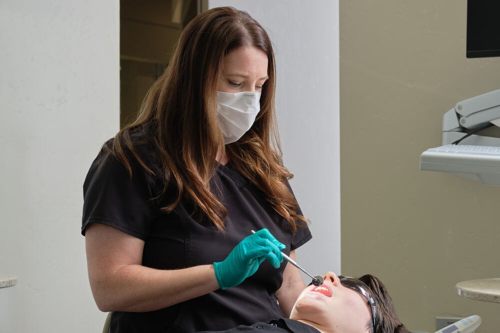 Dr. Ashley Harrison with patient in dental chair